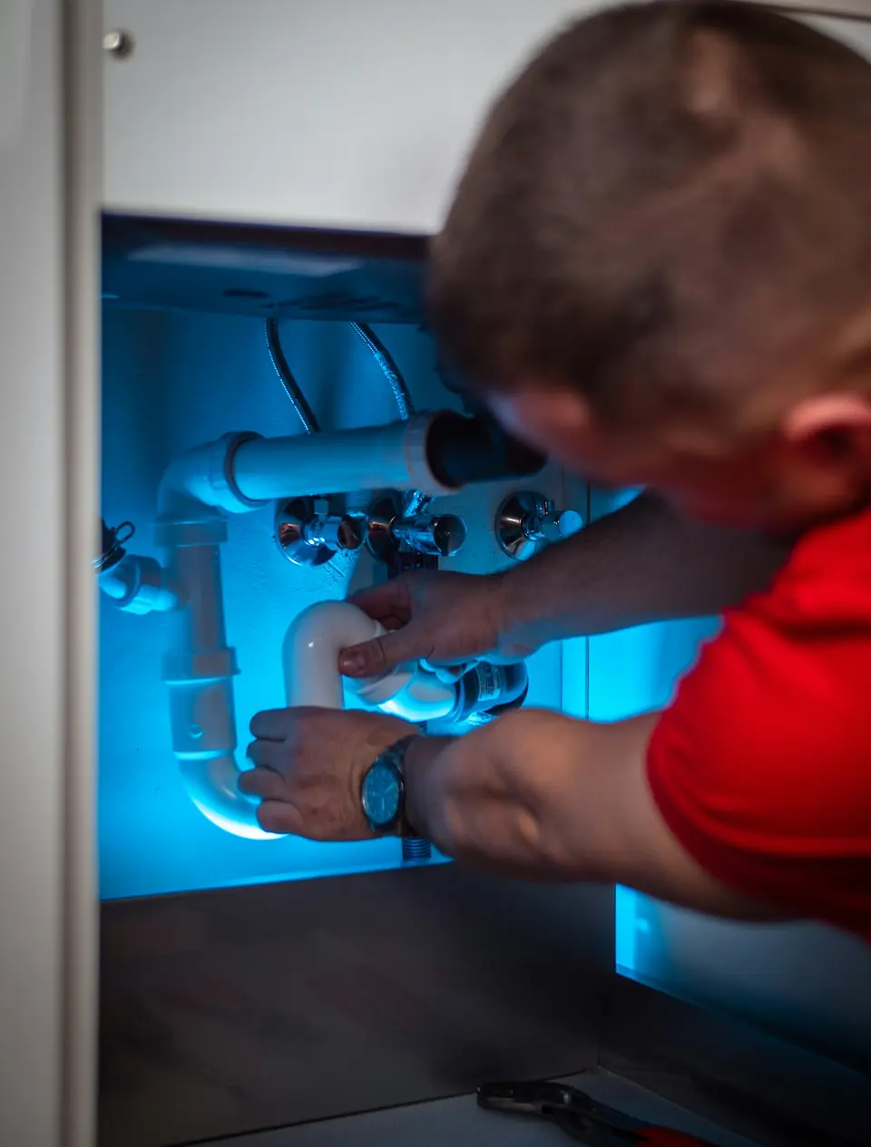 Licensed plumber working on a residential repair